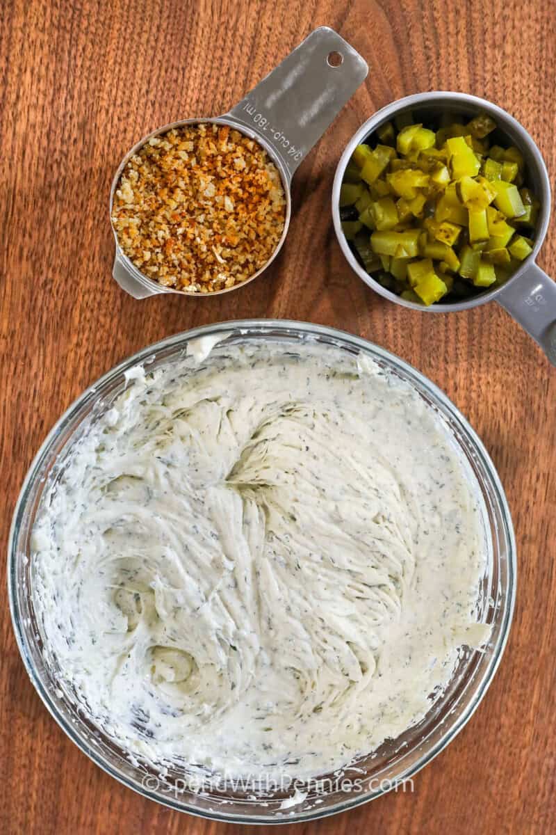 mixed ingredients to make Fried Pickle Dip with a cup of panko breadcrumbs and pickles