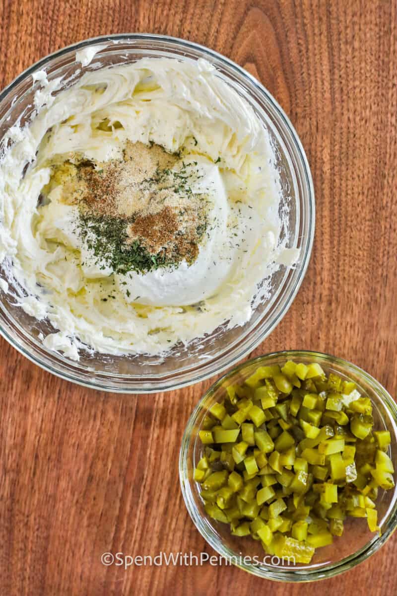 ingredients to make Fried Pickle Dip in a bowl and a bowl of pickles