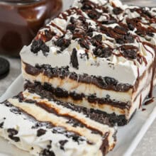 Oreo Ice Cream Cake on a plate with a slice cut out