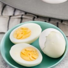 Hard Boiled Eggs in the Oven cut into half on a plate