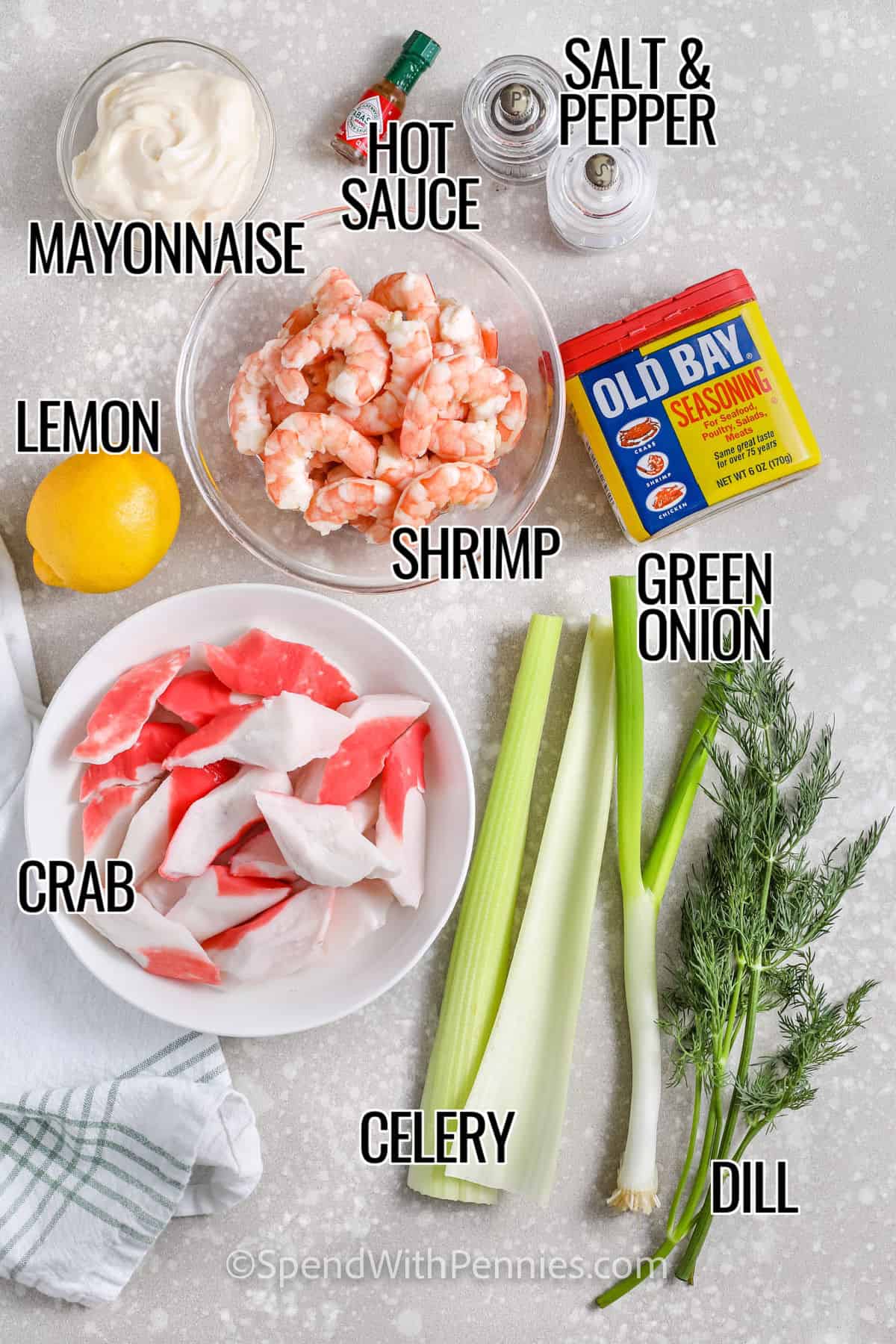 mayonnaise , hot sauce , shrimp , lemon, crab , celery , green onion , dill , old bay seasoning , salt and pepper with labels to make Seafood Salad with titles