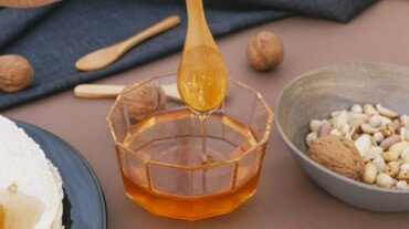 A bowl of honey with a spoon.