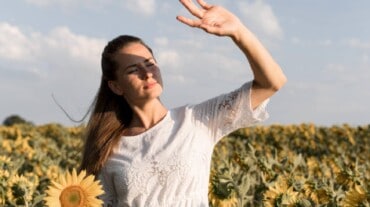 A woman shielding herself from the sun to prevent sun poisoning