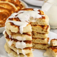 Cinnamon Roll Pancakes with a part taken out to show the inside