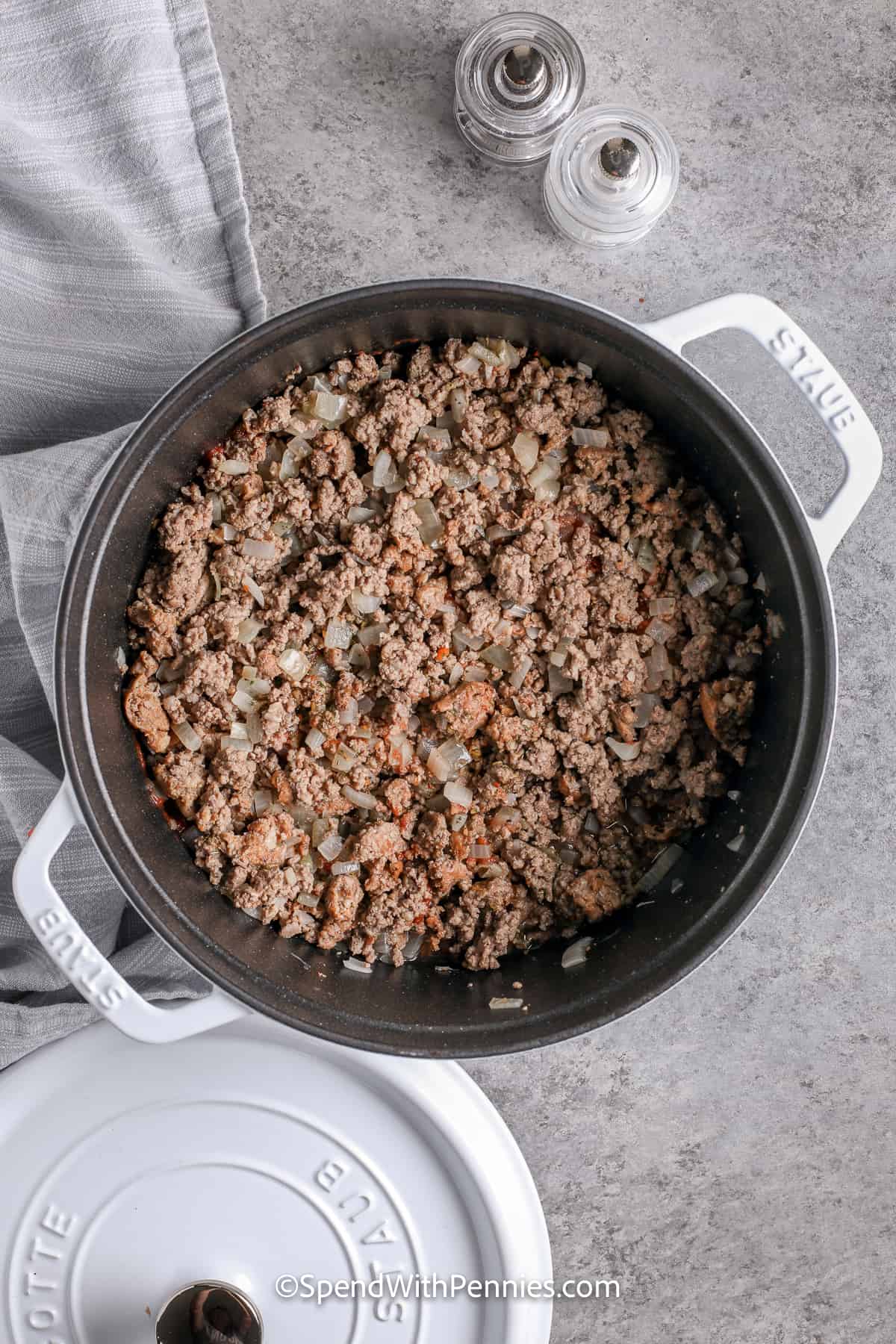 cooked ground beef, sausage, and onions in a pot