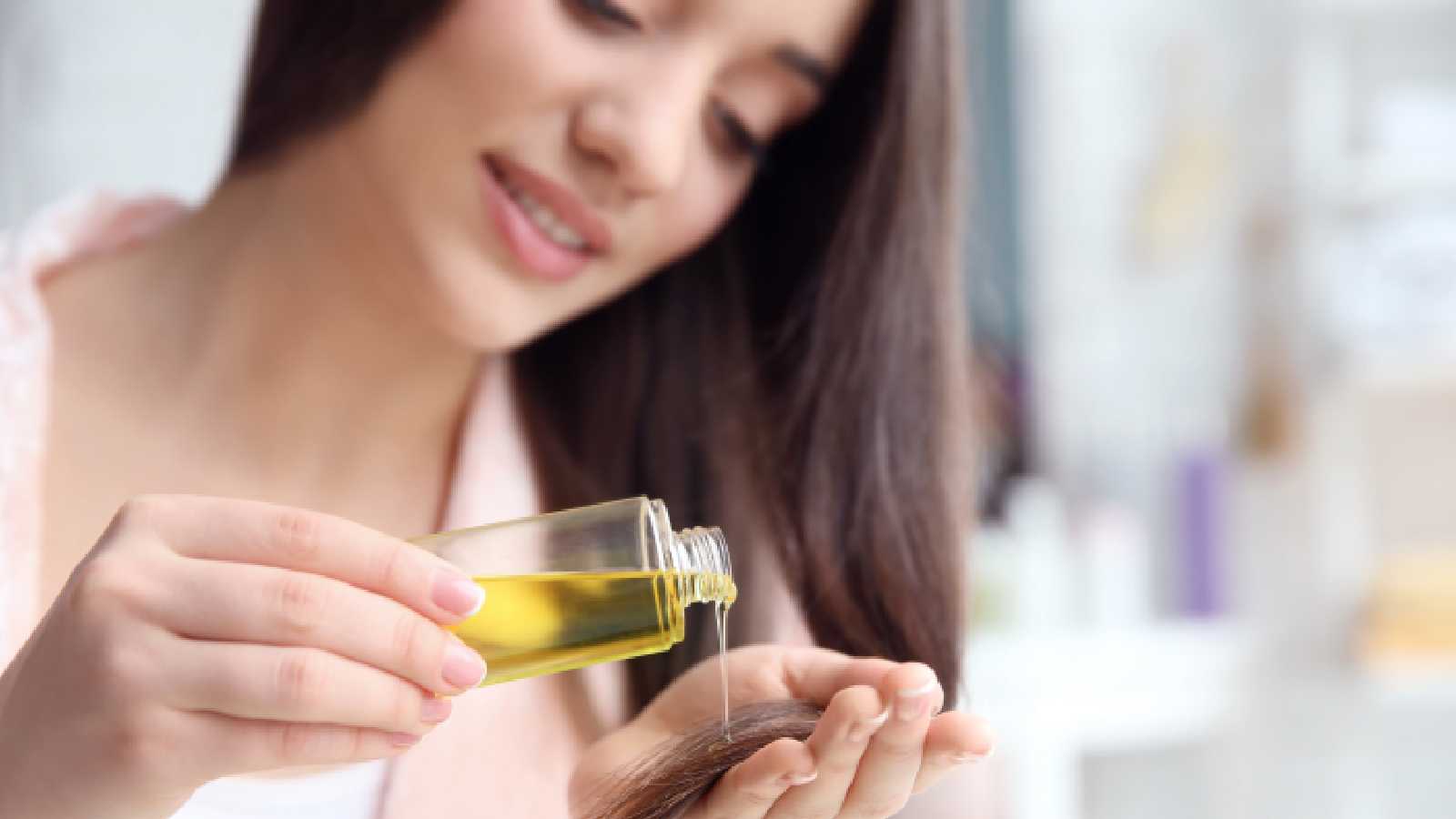 Woman using black seed oil for hair growth