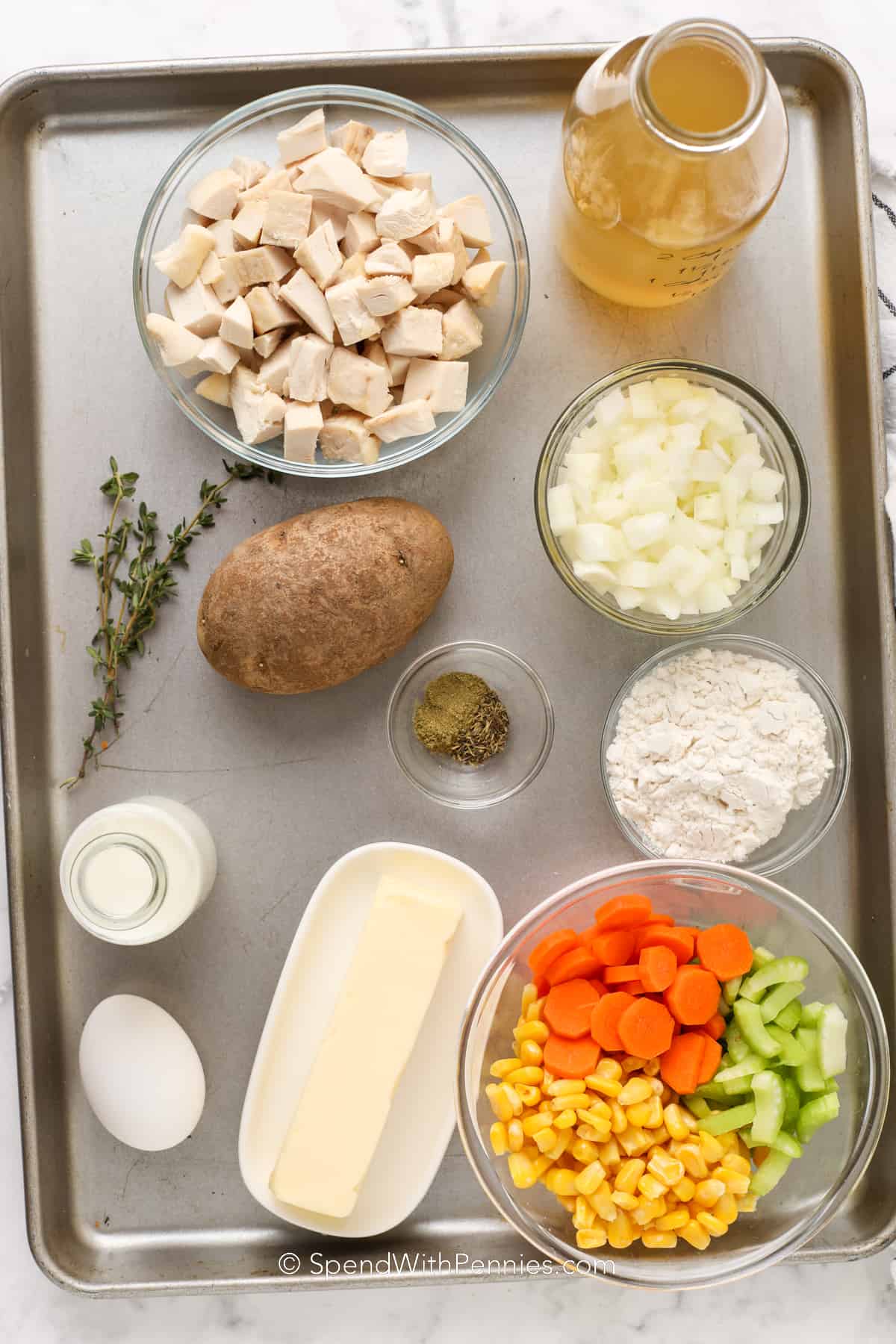 ingredients for chicken pot pie on a baking sheet