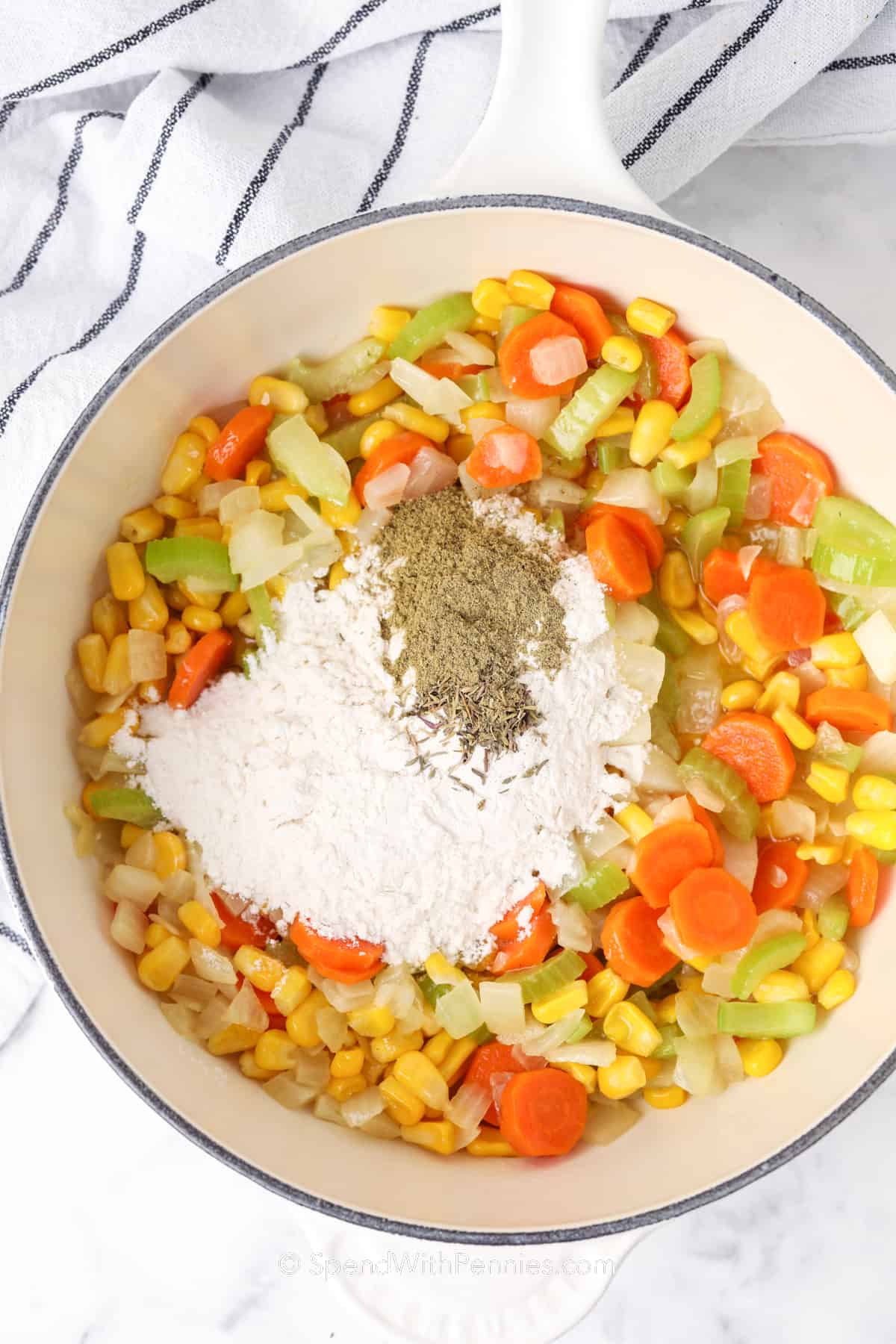 vegetables, flour and seasonings in a white saucepan