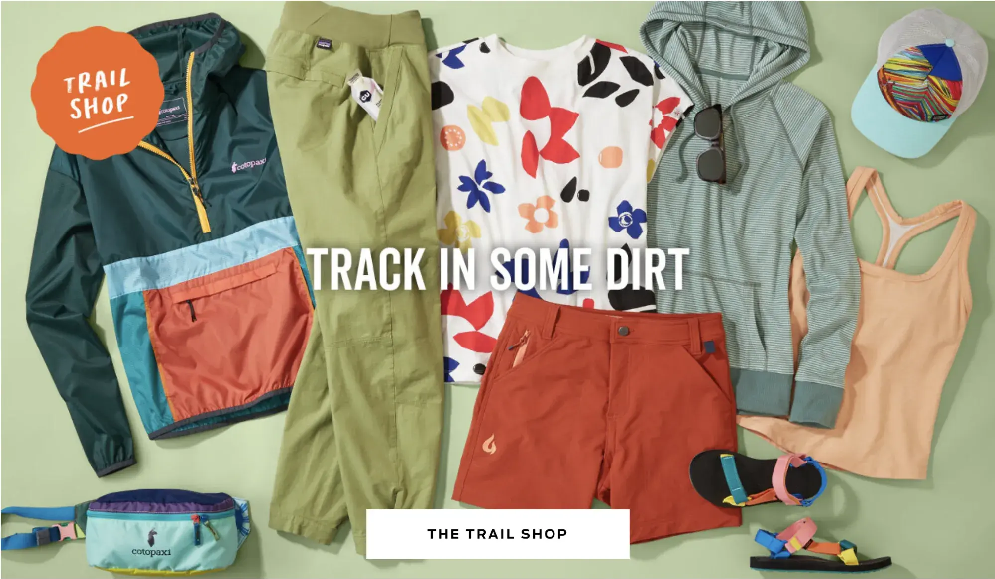 Screencap of a Title Nine product page. Brightly colored clothes are arranged under the text, “track in some dirt.”