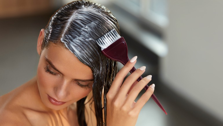 Woman applying hair mask for coloured hair