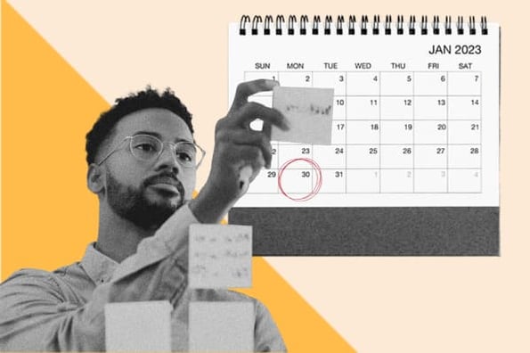 a man organizes sticky notes in front of a calendar as he maps out a 30-60-90 day plan