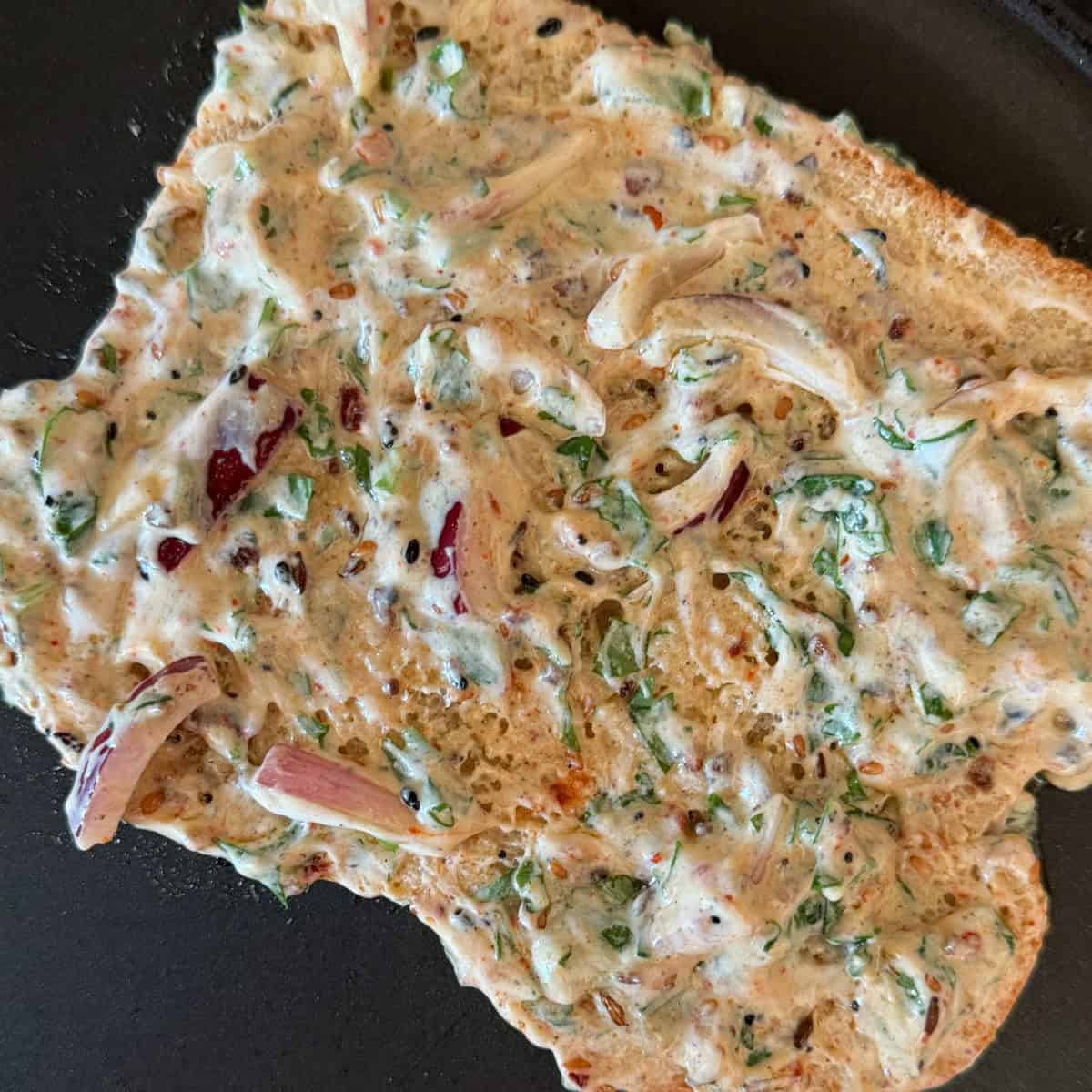 Step 4 of Savory French Toast - Bread coated with yogurt mixture and placed on a griddle pan