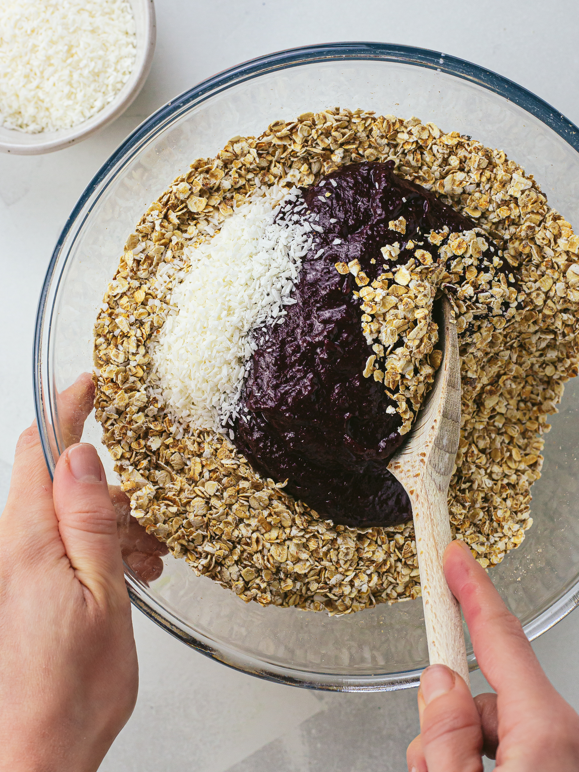 oats, cherry puree and desiccated coconut in a bowl for flapjack dough