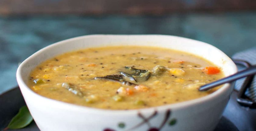 White bowl with vegetable kootu curry.